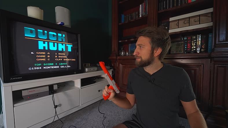 Gav from The Slow Mo Guys readying his NES Zapper for Duck Hunt (1989)
