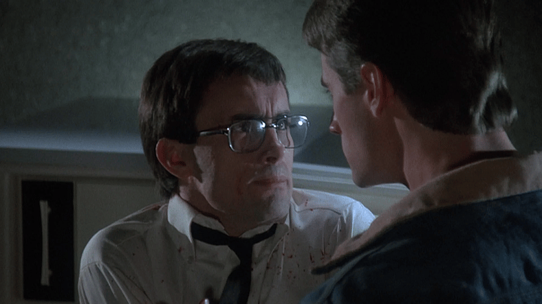 Herbert (Jeffrey Combs) prepares to show Dan (Bruce Abbott) his work in Re-Animator (1985), Empire