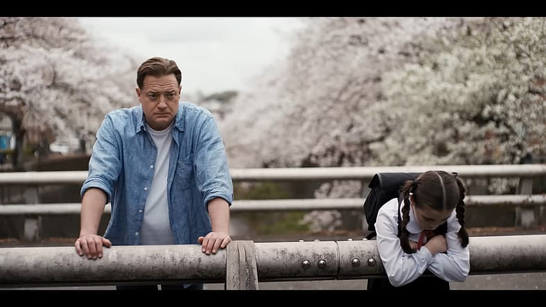 Phillip Vandarploeug (Brendan Fraser) lends Mia (Shannon Mahina Gorman) in Rental Family (2025)