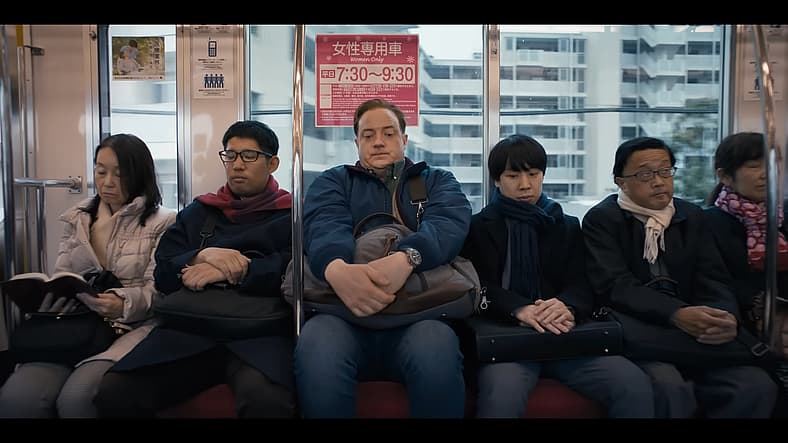 Phillip Vandarploeug (Brendan Fraser) squeezes into a Japanese subway car in Rental Family (2025)