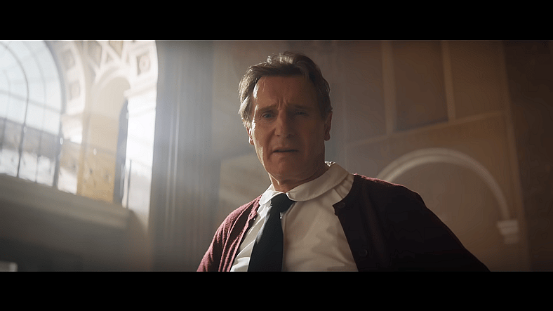 Frank Drebin Jr. (Liam Neeson) introduces himself to hostages in The Naked Gun (2025), Paramount