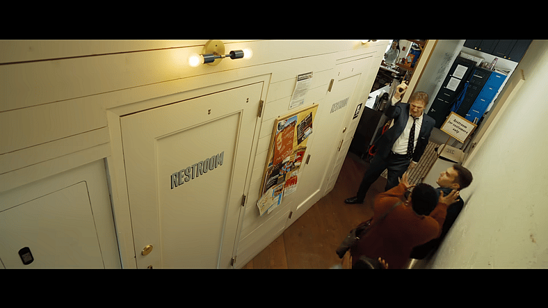 Frank Drebin Jr. (Liam Neeson) requests restroom in The Naked Gun (2025), Paramount Pictures