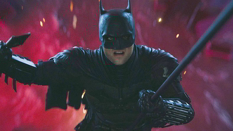 Batman (Robert Pattinson) narrowly escapes The Riddler's (Paul Dano) attempt to drown him in The Batman (2022), Warner Bros. Pictures