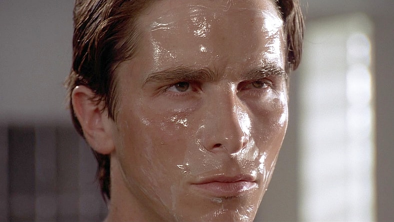 Patrick Bateman (Christian Bale) undertakes his morning skincare routine in American Psycho (2000), Lionsgate Films