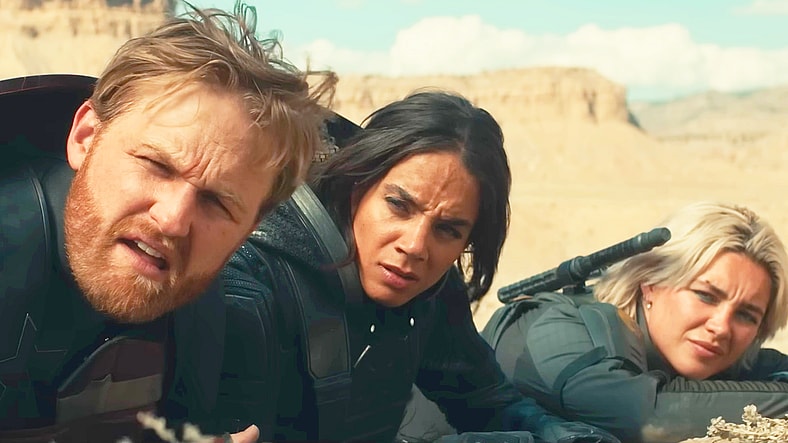 John Walker (Wyatt Russell), Ghost (Hannah John-Kamen), and Yelena (Florence Pugh) catch sight of a fast-approaching vehicle in Thunderbolts (2025), Marvel Entertainment