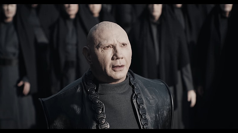 Glossu Rabban (Dave Bautista) watches on as his uncle, The Baron (Stellan Skarsgård), addresses the crowds in Dune: Part Two (2023), Warner Bros. Discovery