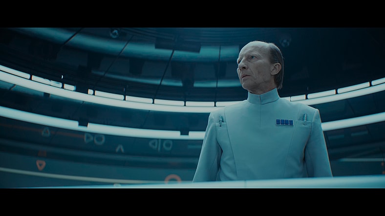 Captain Lagret (Michael Jenn) orders the arrest of Mon Mothma (Genevieve O'Reilly) in Andor Season 2 Episode 9 "Welcome to the Rebellion" (2025), Lucasfilm