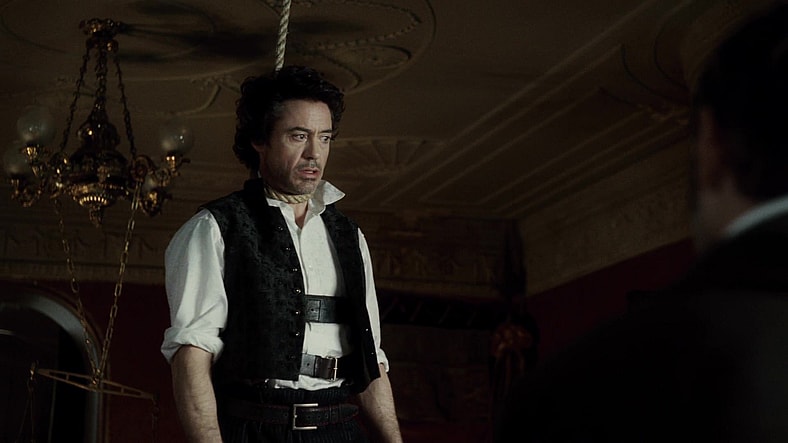 Holmes (Robert Downey Jr.) attempts to deduce the circumstances behind a recent hanging in Sherlock Holmes (2009), Warner Bros. Pictures