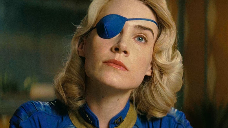 Steph Harper (Annabel O'Hagan) finds that Chet (Dave Register) is getting on her nerves in Fallout Season 2 Episode 7 "The Handoff" (2026), Amazon