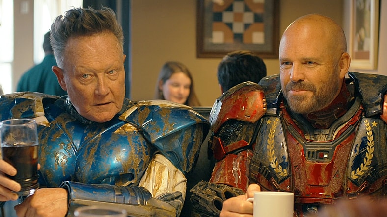 Blue Dragon (Robert Patrick) and Captain Triumph (David Denman) enjoy a post-kaiju breakfast in Peacemaker Season 2 Episode 6 "Ignorance is Chris" (2025), DC Studios