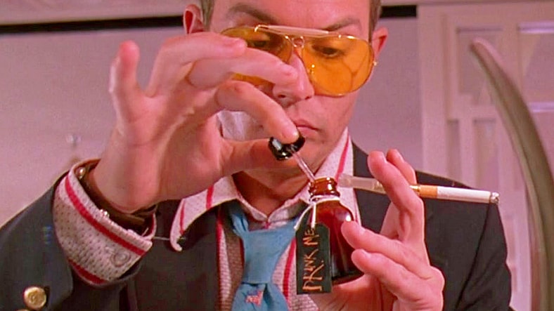 Raoul Duke (Johnny Depp) takes Dr. Gonzo's (Benicio Del Toro) medication advice in Fear and Loathing in Las Vegas (1998), Universal Pictures