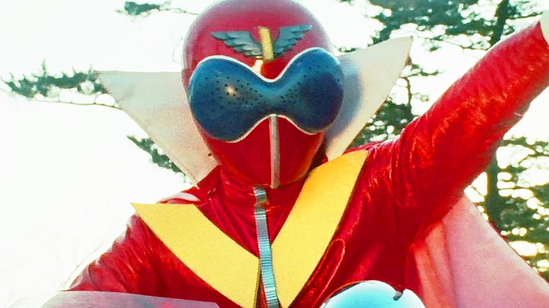 Akarenger (Naoya Makoto) introduces the world to the concept of transforming heroes in Himitsu Sentai Gorenger Episode 1 "The Crimson Sun! The Invincible Gorengers" (1975), Toei Co. Ltd.