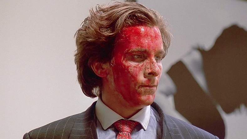 Patrick Bateman (Christian Bale) takes a breather after killing Paul (Jared Leto) in American Psycho (2000), Lionsgate Films