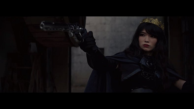 Emiru draws a gun while dressed as a queen promoting OTK via YouTube