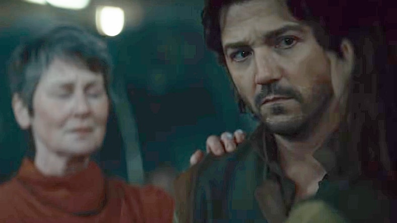 A Force Healer (Josie Walker) offers her assistance to a wary Cassian Andor (Diego Luna) blaster wound in Andor Season 2 Episode 7 "Messenger" (2025), Lucasfilm