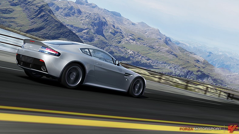 An Aston Martin V12 Vantage races past a stunning view in Forza Motorsport 4 (2011), Microsoft Studios