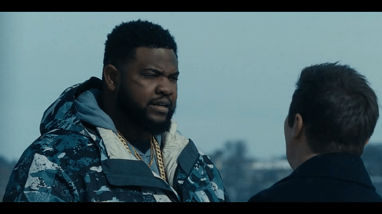 Bunny (Tobi Bamtefa) speaks to Mike McLusky (Jeremy Renner) about the new threat in town in Mayor of Kingstown Season 4 Episode 1 "Coming 'Round the Mountain" (2025), Paramount Network