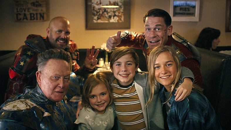 Blue Dragon (Robert Patrick), Captain Triumph (David Denman), and Peacemaker (John Cena) pose for a selfie with some adoring fans in Peacemaker Season 2 Episode 6 "Ignorance is Chris" (2025), DC Studios