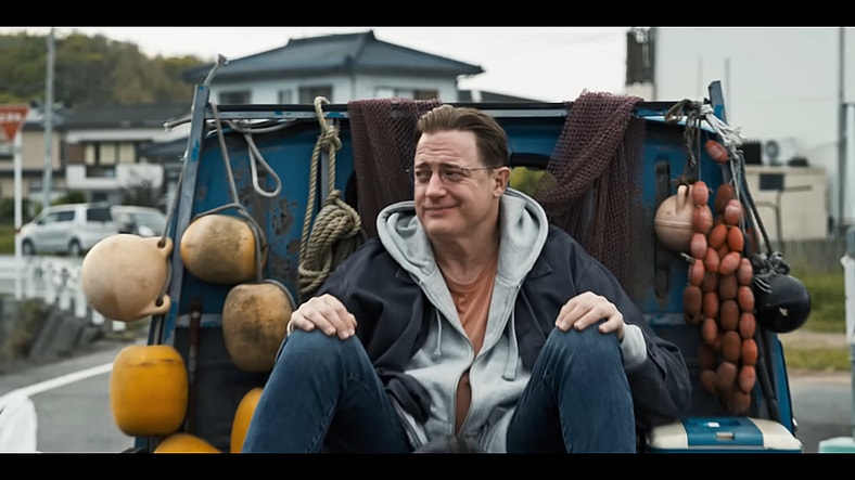 Phillip Vandarploeug (Brendan Fraser) hitches a ride in Rental Family (2025), Searchlight Pictures