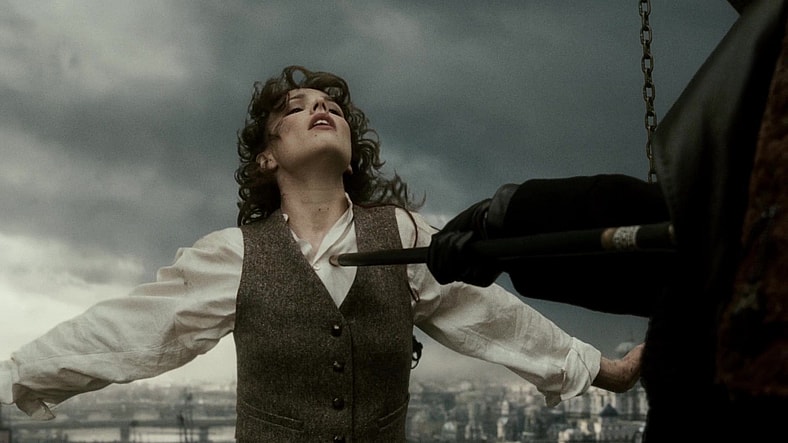 Irene Adler (Rachel McAdams) finds herself at the mercy of Lord Blackwood in Sherlock Holmes (2009), Warner Bros. Pictures