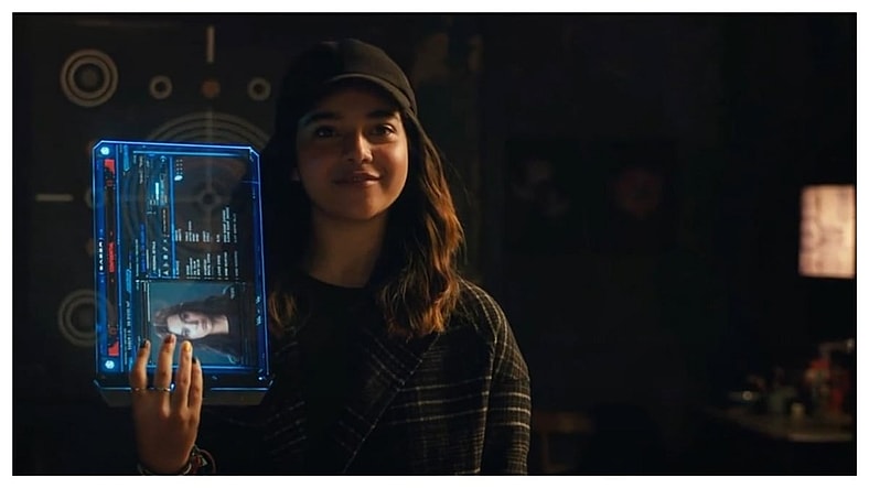 Ms. Marvel (Iman Vellani) shows Kate Bishop (Hailee Steinfeld) her profile on a tablet in the post-credit scene of The Marvels, 2023, Marvel Entertainment