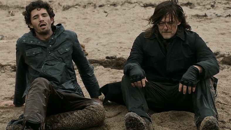 Roberto (Hugo Arbués) and Daryl (Norman Reedus) take a breather after surviving a Walker attack in The Walking Dead: Daryl Dixon Season 3 Episode 3 "El Sacrificio" (2025), AMC