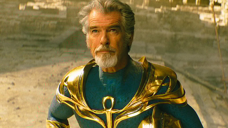 Doctor Fate (Pierce Brosnan) gives a passing grade to Atom Smasher's (Noah Centineo) JSA debut in Black Adam (2022), Warner Bros. Pictures