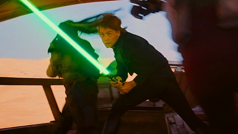 Luke Skywalker (Mark Hamill) fights his way through Jabba's (David Barclay/Toby Philpott/Mike Edmonds/Larry Ward) forces in Star Wars: Episode VI - Return of the Jedi (1985), Lucasfilm