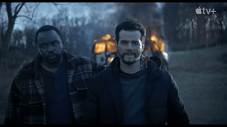 Ray Driscoll (Brian Tyree Henry) and Manny Carvalho (Wagner Moura) walking away from an exploding car in Dope Thief Season 1 Episode 1 "Jolly Ranchers" (2025), Apple TV+