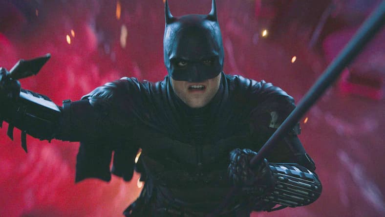 Batman (Robert Pattinson) narrowly escapes The Riddler's (Paul Dano) attempt to drown him in The Batman (2022), Warner Bros. Pictures
