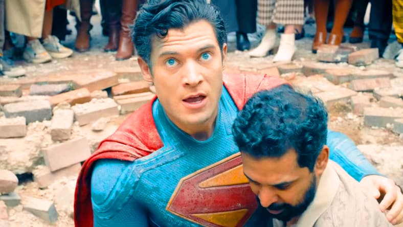 The Man of Steel (David Corenswet) receives some help up from Mali (Dinesh Thyagarajan) after taking a knocking from the Hammer of Boravia in Superman (2025), DC Studios