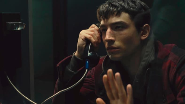 Barry Allen (Ezra Miller) watches as his father Henry Allen (Billy Crudup) is taken back to his cell in Zack Snyder's Justice League (2021), Warner Bros. Entertainment