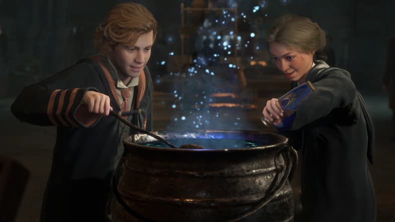 A Griffindor and Ravenclaw student brew a potion in a cauldron, as blue sparks float up from it via Hogwarts Legacy (2023), Warner Bros. Interactive Entertainment