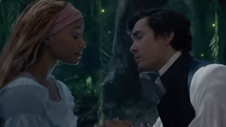 Prince Eric (Jonah Hauer-King) moves in to kiss Ariel (Halle Bailey) in The Little Mermaid (2023), Disney