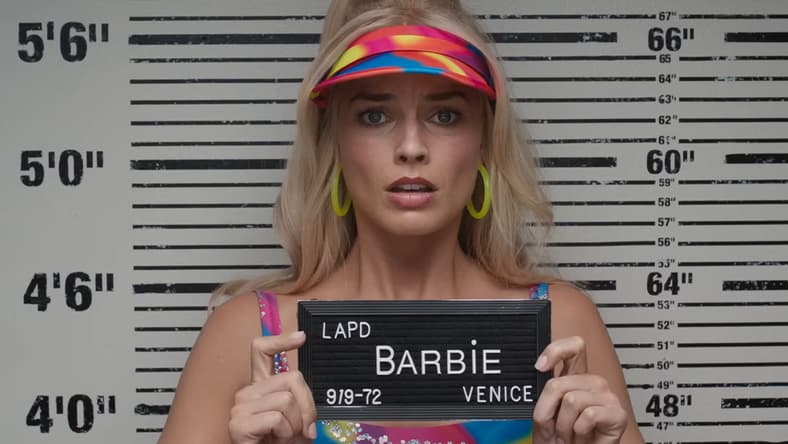 Barbie (Margot Robbie) is arrested in Los Angeles n in Barbie (2023), Warner Bros. Pictures