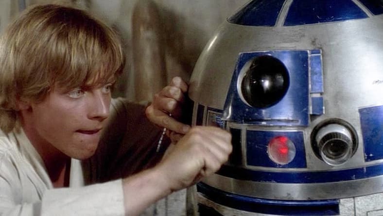 Luke Skywalker (Mark Hamill) attempts to fix his newly-purchased R2 unit (Kenny Baker) in Star Wars - Episode IV: A New Hope (1977), Lucasfilm