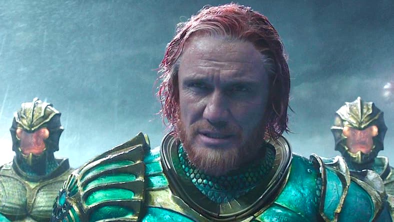 King Nereus (Dolph Lundgren) patiently watches as the battle between Aquaman (Jason Momoa) and Ocean Master (Patrick Wilson) unfolds in Aquaman (2018), Warner Bros. Pictures