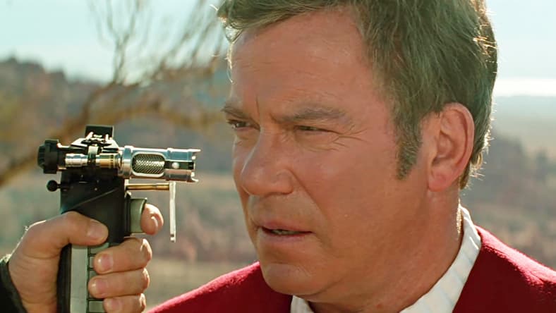 Captain Kirk (William Shatner) finds himself held at Phaser-point by Tolian Soran (Malcolm McDowell) in Star Trek Generations (1994), Paramount Pictures