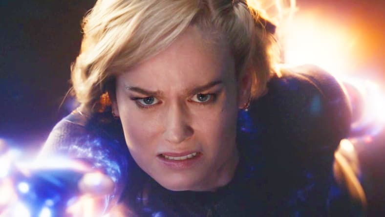 Captain Marvel (Brie Larson) tries and fails to rescue Monica Rambeau (Teyonnah Parris) from the multiverse in The Marvels (2023), Marvel Entertainment