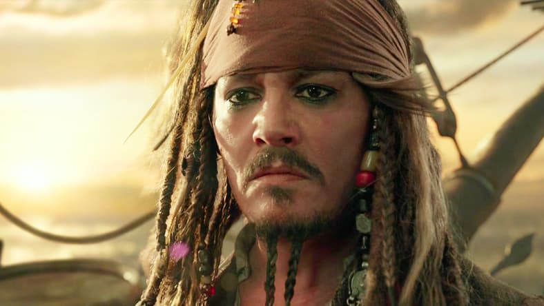 Captain Jack (Johnny Depp) bids farewell to Henry (Brenton Thwaites), Carina (Kaya Scodelario), Will (Orlando Bloom) and Elizabeth (Keira Knightley) in Pirates of the Caribbean: Dead Men Tell No Tales (2017), Disney