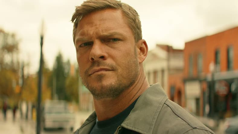 Jack (Alan Ritchson) takes notice of a less-than-savory character in Reacher Season 2 Episode 1 "ATM" (2023), Amazon
