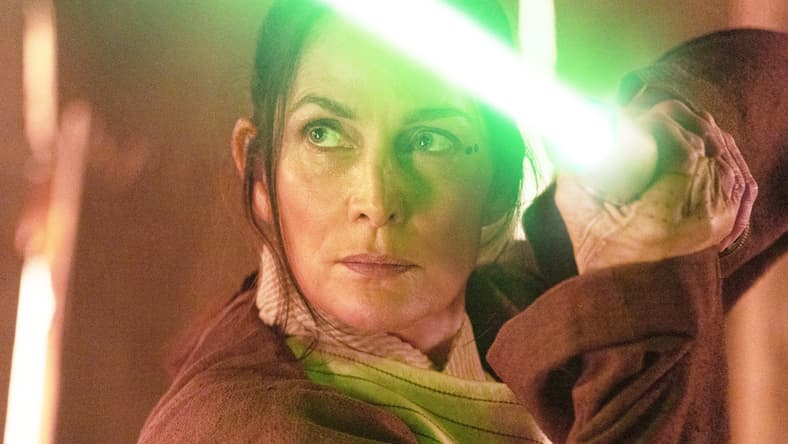 Jedi Master Indara (Carrie-Anne Moss) draws her lightsaber in The Acolyte (2024), Disney