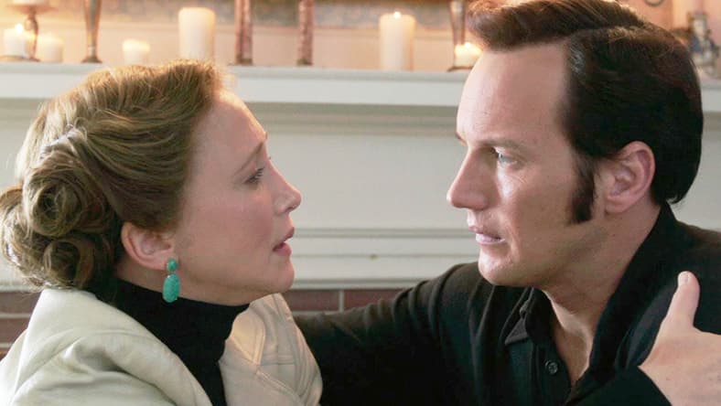 Lorraine Warren (Vera Farmiga) warns Ed (Patrick Wilson) of their next mission in The Conjuring 2 (2016), New Line Cinema