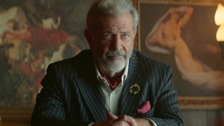 Cormac (Mel Gibson) interrogates Winston (Colin Woodell) for information regarding Frankie's (Ben Robson) location in The Continental: From the World of John Wick Episode 1 "Brothers in Arms" (2023), Lionsgate Television