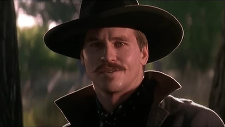 Doc Holliday (Val Kilmer) is about to show Johnny Ringo (an offscreen Michael Biehn) what it means to "play for blood" in Tombstone (1993) Buena Vista Pictures/Cinergi