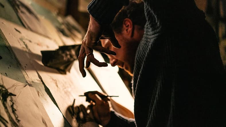 The man (Benedict Cumberbatch) sketches out a crow in The Thing with Feathers (2025), Film4