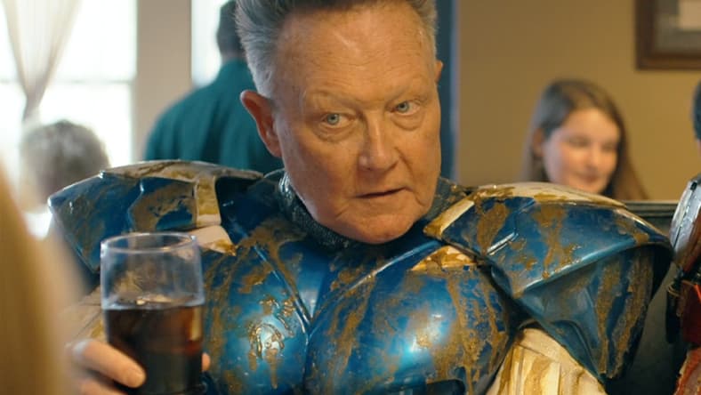 Blue Dragon (Robert Patrick) raises a glass to the Top Trio's latest victory in Peacemaker Season 2 Episode 6 "Ignorance is Chris" (2025), DC Studios