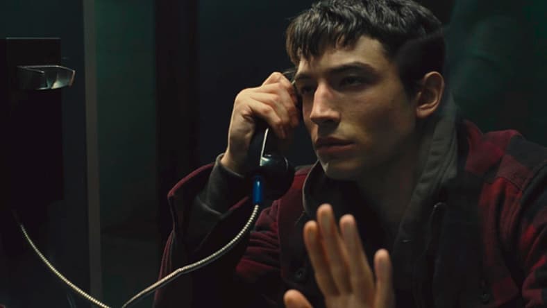 Barry Allen (Ezra Miller) watches father Henry Allen (Billy Crudup) taken to cell in Zack Snyder's