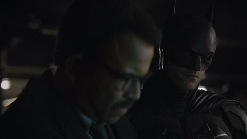 Lt. Gordon (Jeffrey Wright) and Batman (Robert Pattinson) figure out what's on a thumb drive in The Batman (2022), Warner Bros. Pictures