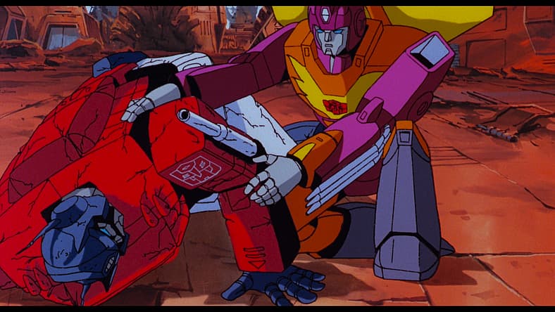 Hot Rod (Judd Nelson) rushes to wounded Optimus Prime (Peter Cullen) in The Transformers: The Movie